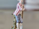 a figurine of a man with a stick on a table