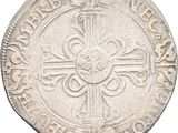a close up of a coin with a cross on it