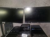 three televisions and a remote control sitting on a table