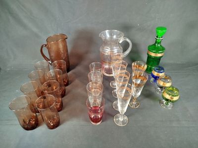 a lot of glasses and a pitcher on the table
