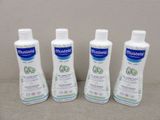 three bottles of moist lotion sitting next to each other