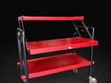an image of a red utility cart on wheels against a black background