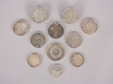 several different types of coins arranged in a circle on a white surface