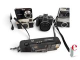 three cameras that are sitting next to each other on a table
