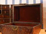 a wooden box sitting on top of a table next to a dresser