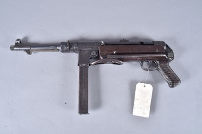 a close up of a gun with a tag attached to it