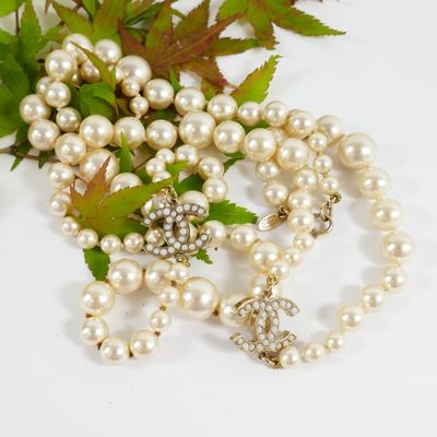 a bunch of pearls and a broocher on a table