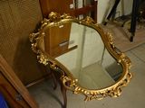a mirror that is sitting on a chair in a room
