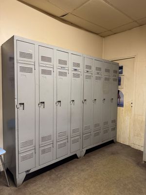 a room with a bunch of lockers and a chair in it
