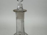 a clear glass bottle with a diamond on the top