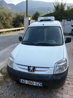 a small white van parked on the side of the road