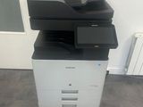 a black and white printer sitting on top of a white cabinet