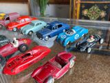 a lot of toy cars on display in a glass case