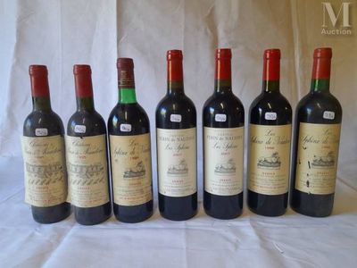 six bottles of wine are lined up on a table