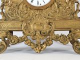 a gold clock that is sitting on top of a table