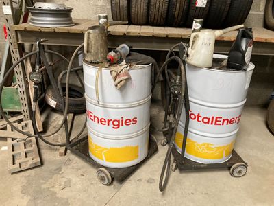 two white barrels sitting next to each other in a garage
