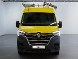 the yellow van is parked in a large room with a ladder on the roof