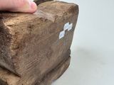 a person holding a piece of wood with a cross on it