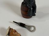 a bottle opener, a bottle opener, and a cork opener on a table