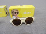 a pair of sunglasses sitting next to a box on the ground