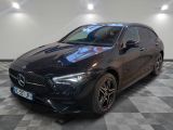 a black mercedes cla parked in a garage with a checkered floor