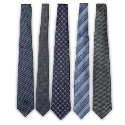 four ties are lined up in a row on a white surface