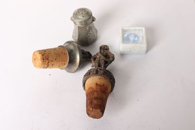 three wine corks sitting on a table next to a bottle