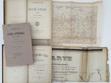 several old books are stacked on top of each other on a table
