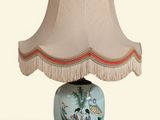 a lamp that is sitting on a table with a lamp shade on it