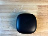 a small black object sitting on a wooden table
