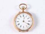 a gold pocket watch with roman numerals on it