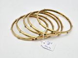 a close up of a stack of bangles with a tag on it