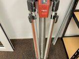 a tripod with a camera attached to it in a room