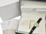 a watch that is in a box with papers and papers