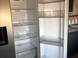 an open refrigerator in a kitchen with a lot of shelves