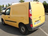 a small yellow van parked in a parking lot