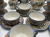 many different types of tea and coffee cups and saucers on the table