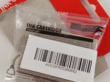 a package of ink cartridges sitting on top of a piece of paper
