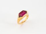 a close up of a gold ring with a red stone