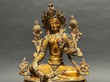 an image of a gold statue of a person sitting in a lotus position
