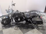 a black motorcycle that is parked on a checkered floor