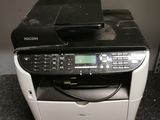 a black and white printer sitting on the floor