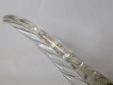 a glass sculpture of a bird on a white surface