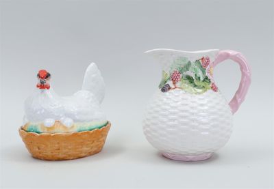 pair of porcelain figurines of chickens and a basket of strawberries