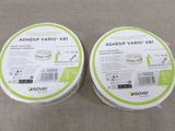two tubs of adhesive varico tubs sitting on a table