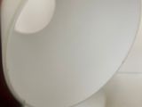 a white lamp that is sitting on top of a table