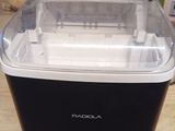 a small black and white ice maker sitting on a table