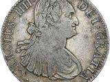 une pièce en argent avec l'image d'une femme de profil