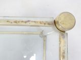 a close up of a mirror on a white wall