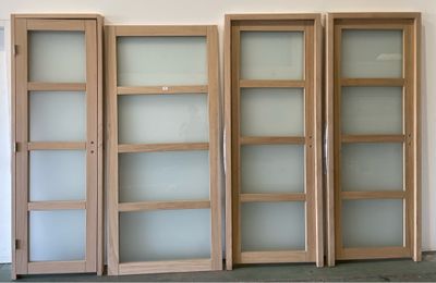 four wooden doors with frosted glass doors in a room